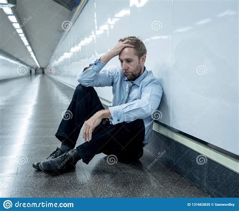 Young Jobless Business Man Suffering Depression Sitting On Ground