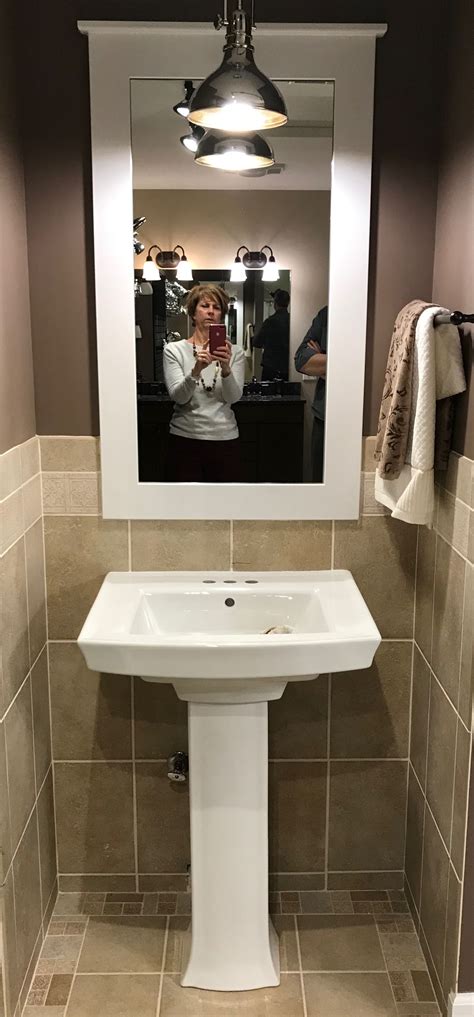 Square Pedestal Sink And Framed Mirror Over Sink Lighting Bathroom