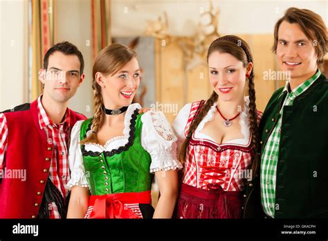 Young People In Traditional Bavarian Tracht In A Business Or Restaurant