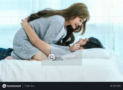 Lover Kissing And Hugging On The Bed In Bedroom At Modern Home Photo In