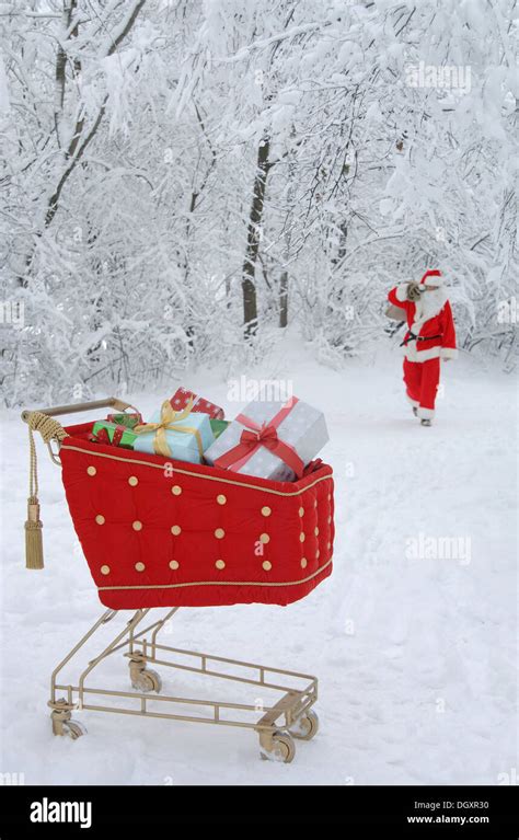 Santa Claus In A Snowy Forest With A Shopping Cart With Red Velvet And