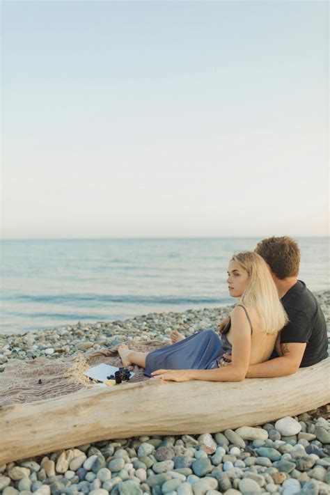 Couple Sitting On Beach Shore · Free Stock Photo