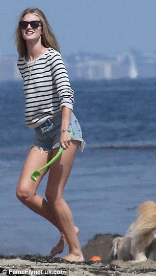 Rosie Huntington Whiteley Shows Off Her Long Toned Legs Again As She Plays Fetch On The Beach