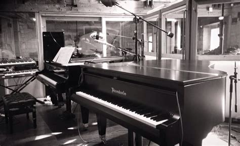 A Black And White Photo Of A Piano In A Recording Studio