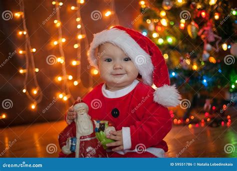 The Baby Around The Christmas Tree With Lights Stock Photo Image Of