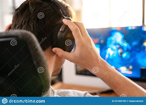 Caucasian Brunette Guy In Headphones Playing Video Game On His Computer Stock Image Image Of