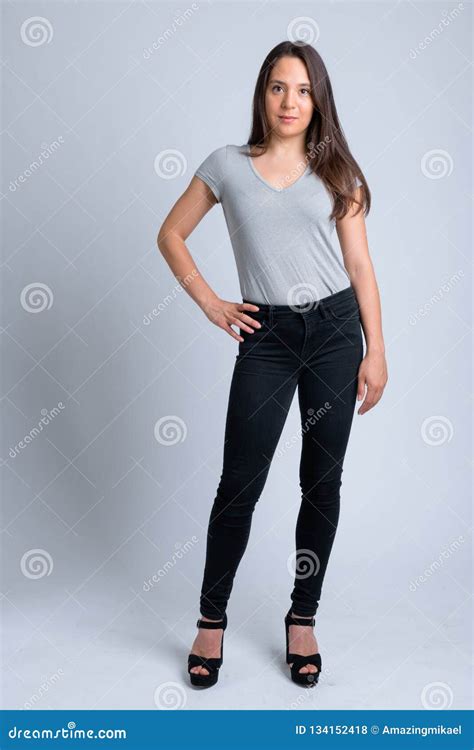 Full Body Shot Of Young Beautiful Multi Ethnic Woman Thinking While
