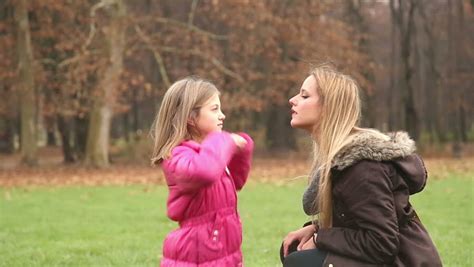 Girl Comforting Her Female Friend With Kiss And Hug Action On Natural Background Stock Footage