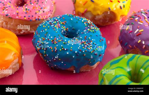 A Batch Of Rainbow Colored Glazed Donuts Stock Photo Alamy