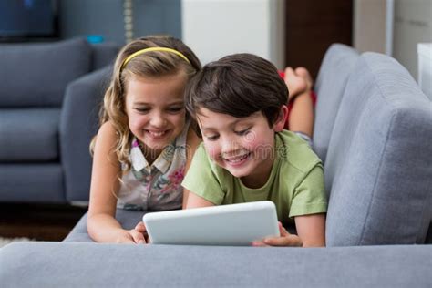 siblings using digital tablet in living room stock image image of lifestyle caucasian 91760601