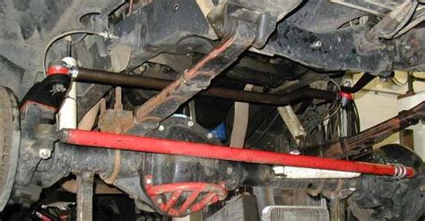 The Front End Of A Vehicle With Some Red Pipes And Other Parts Attached