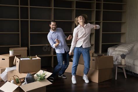 Cheerful Happy Young Married Couple Moving Into First Home Stock Photo