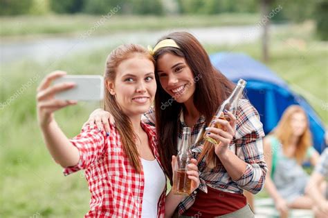 Happy Women Taking Selfie By Smartphone At Camping Stock Photo Syda