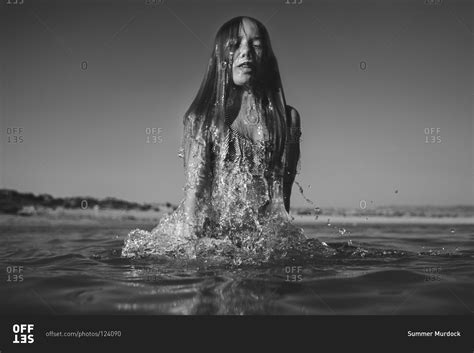 Girl Emerging From The Water Stock Photo Offset