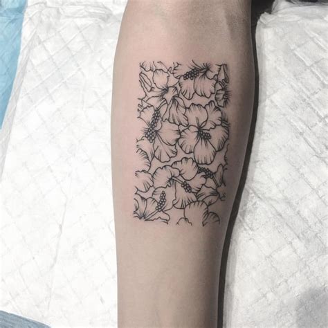 A Black And White Flower Tattoo On The Leg