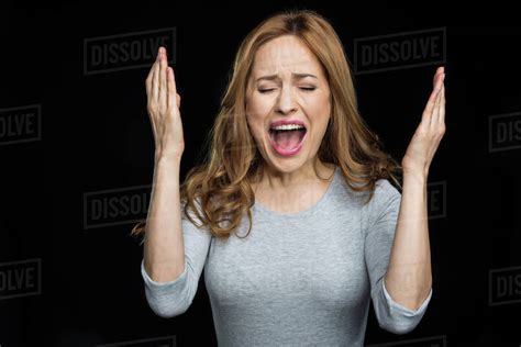 Babe Beautiful Woman Screaming In Exasperate Isolated On Black Stock Photo Dissolve