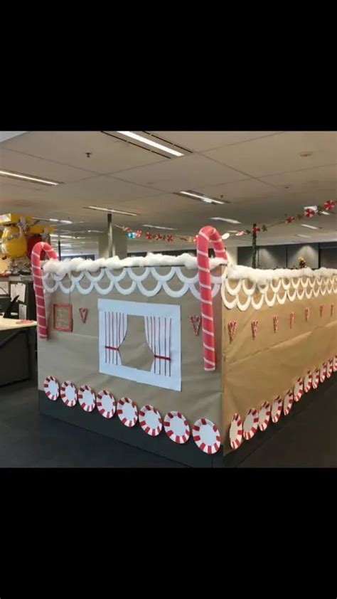 An Office Cubicle Decorated For Christmas With Candy Canes On The Door