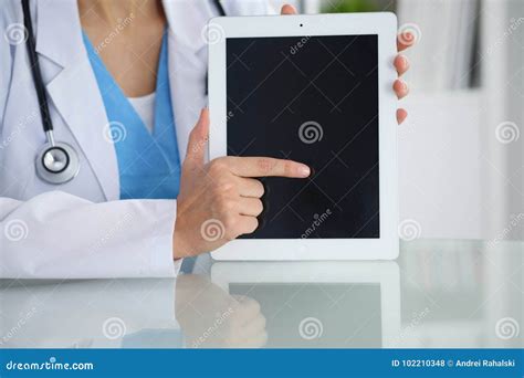 Female Doctor Pointing Into Tablet Computer Close Up Of Hands