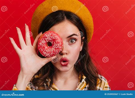 Close Up Portrait Of Naughty Brunette Holding Pink Donut Near Eye Girl In Beret Is Amazedly