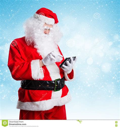 Santa Claus Looking Something Up On His Tablet Stock Photo Image Of