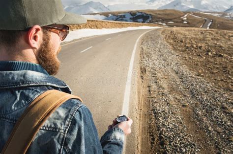 Close Up Hipster Man Using A Compass On A Snowy Mountain Stock Image