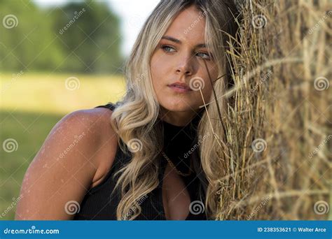 A Lovely Blonde Model Poses Outdoors In A Farm Environment Stock Image