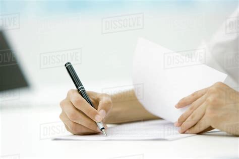 Person Signing Document With Pen Cropped View Of Hands Stock Photo
