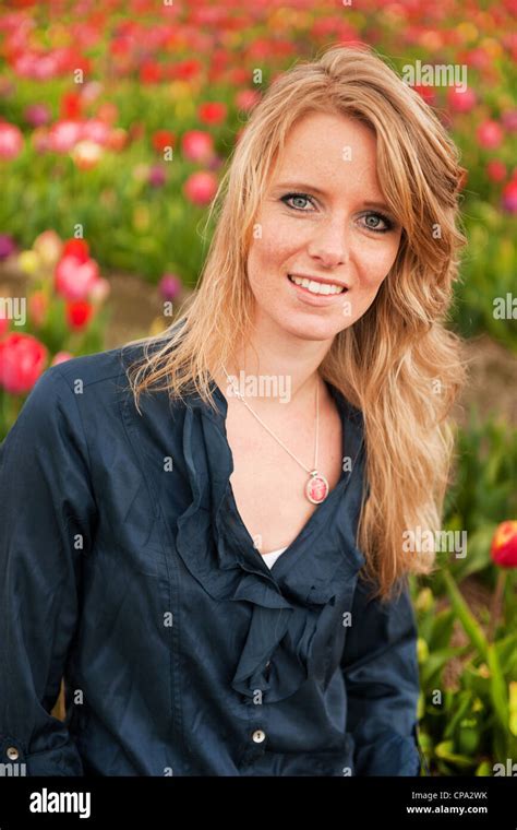 Portrait Of A Beautiful Blond Dutch Girl In Tulips Field Stock Photo Alamy