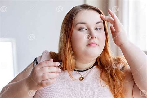 nice chubby red haired woman touching her face stock image image of face look 144580435