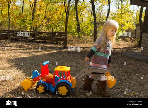 Little Girl Playing With A Colorful Vivid Plastic Toy Construction