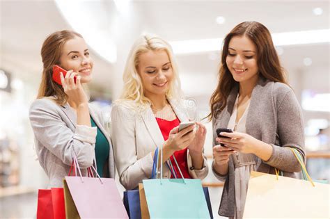 Happy Women With Smartphones And Shopping Bags Stock Photo Image Of