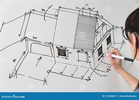 Close Up Of A Young Female Architect Drawing A Sketch For A New Famaly