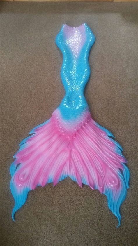 A Pink And Blue Mermaid Tail Laying On The Floor