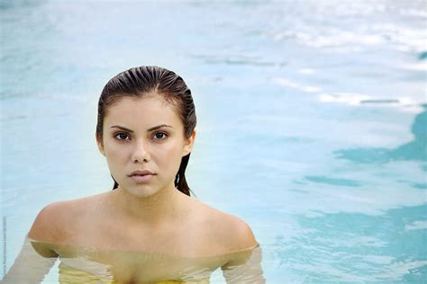 Portrait Of Beautiful Hispanic Woman Relaxing In The Pool At Luxury