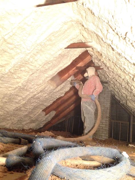 I live in mn, client wanted spray foam inbetween trusses in attic. MPI Foam installing spray foam insulation in attic to keep ...