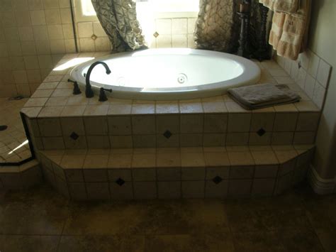 Originally it had three different tiles going on: Drop in jacuzzi tub tile surround by Mingus Tile in ...