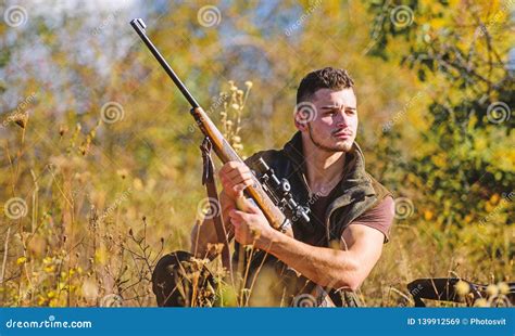 Man Hunting Wait For Animal Hunter With Rifle Ready To Hunting Nature