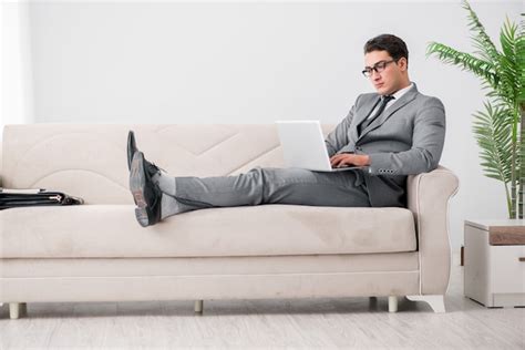 Premium Photo Young Businessman Lying On The Sofa