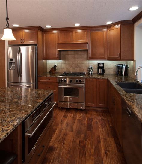 Dark wood floors and white cabinets. Rose Kitchen Cabinets | Littlerock, WA | Cabinets by Trivonna