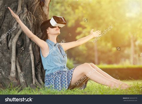 Beautiful Asian Woman Enjoy Virtual Reality Sitting On Grass In Outdoor Park Vr Headset Glasses