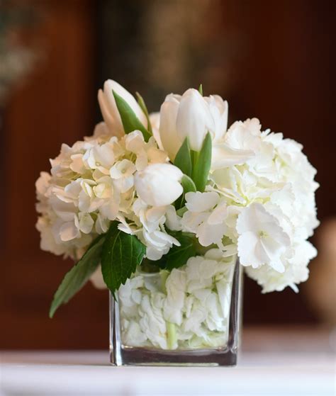 Simple flower centerpiece for cocktail table with white tulips and