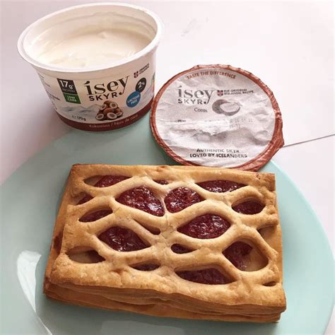 A Waffle On A Plate With Yogurt Next To It And An Ice Cream Container