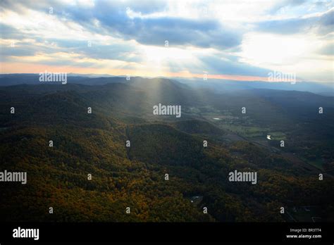 Crepuscular Rays Beam Down From Clouds Above Onto Pinnacle Mountain