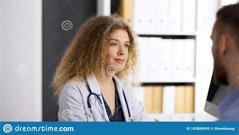 female doctor and male patient discussing current health examination