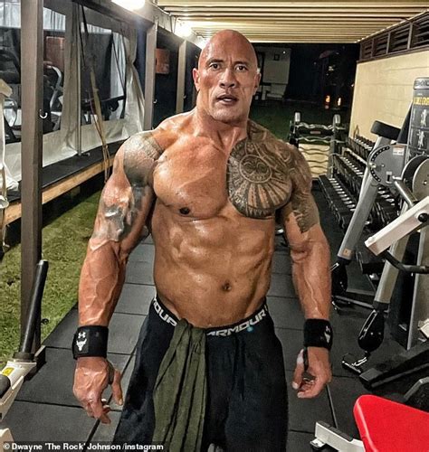 dwayne the rock johnson goes shirtless as he shows off his bulging muscles