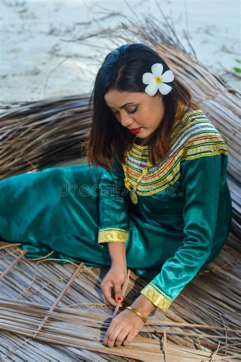 Beautiful Maldivian Woman In Traditional National Dress Making Roof