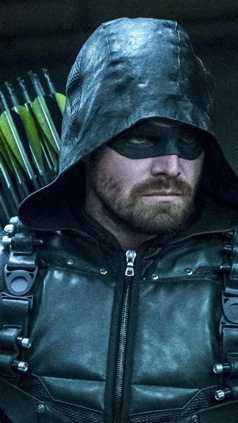 Download Green Arrow In A Black Outfit With Arrows Wallpaper