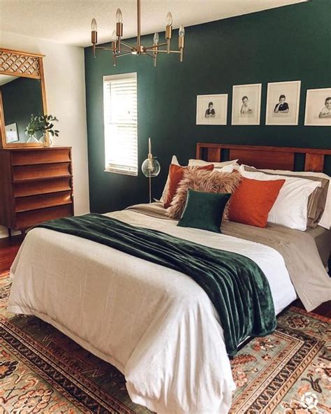 A Mid Century Modern Bedroom With A Dark Green Accent Wall A Stained