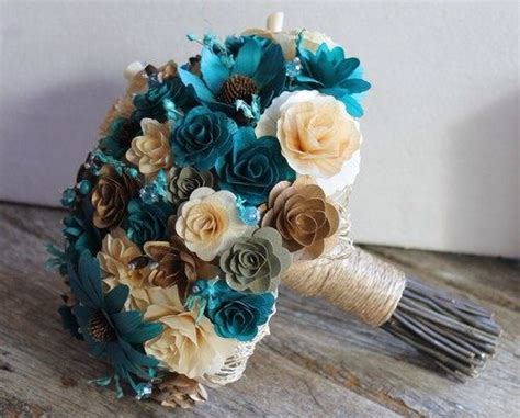 Pale blue velvet heels with white rose and wildflower bouquet wedding party portraits at saddle wood farms in murfreesboro, tennessee bridesmaids in blue dresses for wedding at machine shop in minneapolis, minnesota Brown & Teal wedding bouquets. The flowers are made from ...