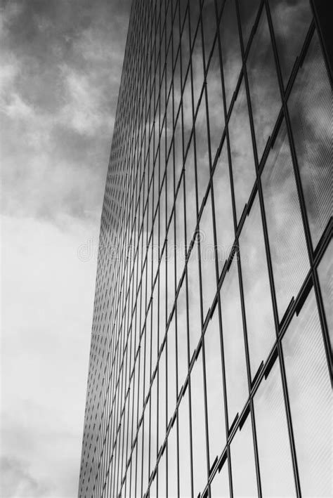 Grayscale Shot Of A Modern High Rise Office Building With Glass Windows